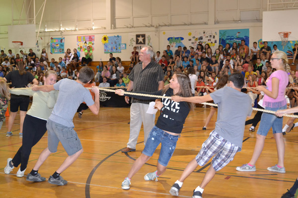 Students playing tug-o-war during an assembly